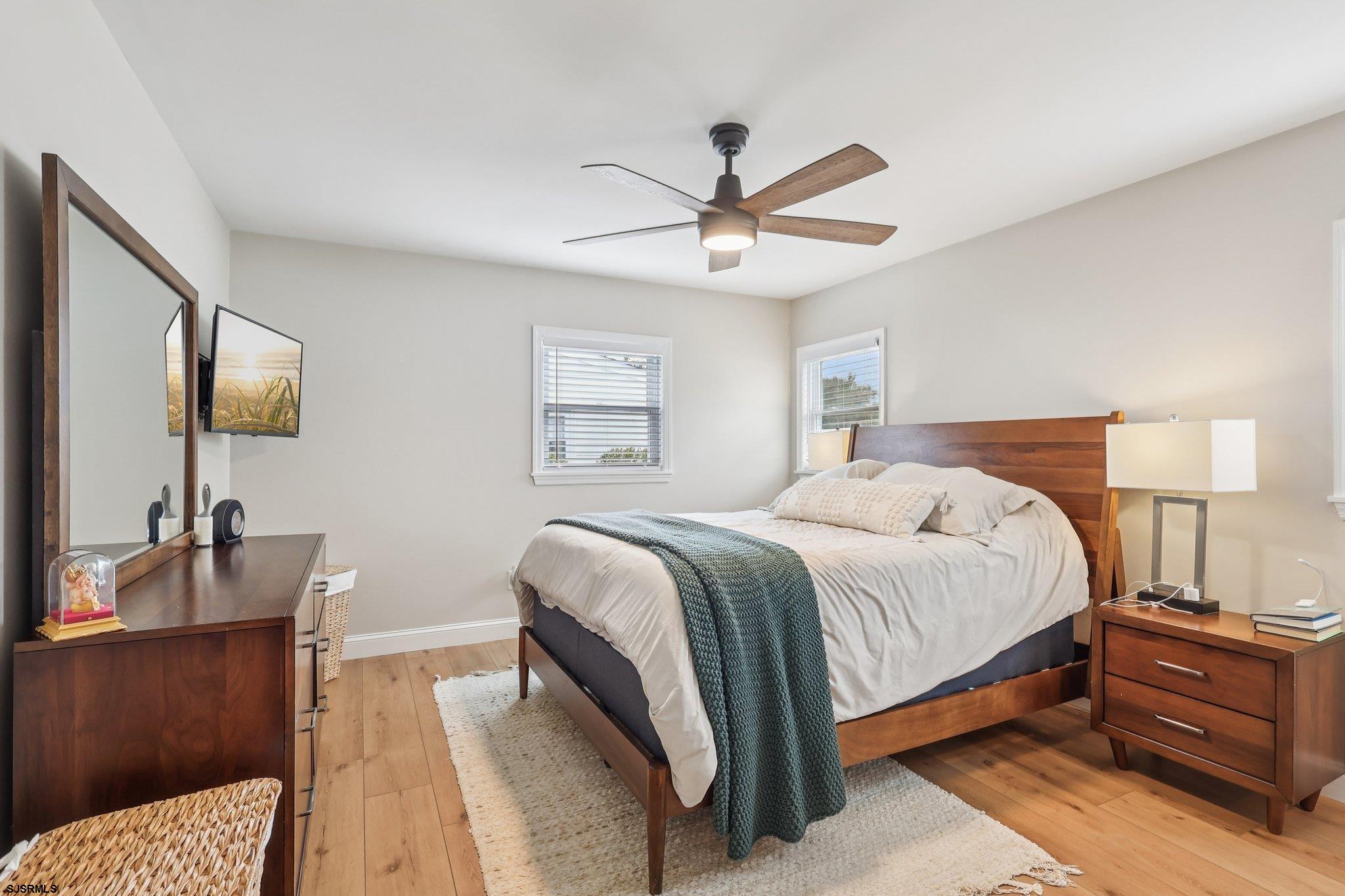 13 Gulph Mill Road Somers Point, NJ 08244 - Photo 29 of 43 a bedroom with a bed and a chandelier