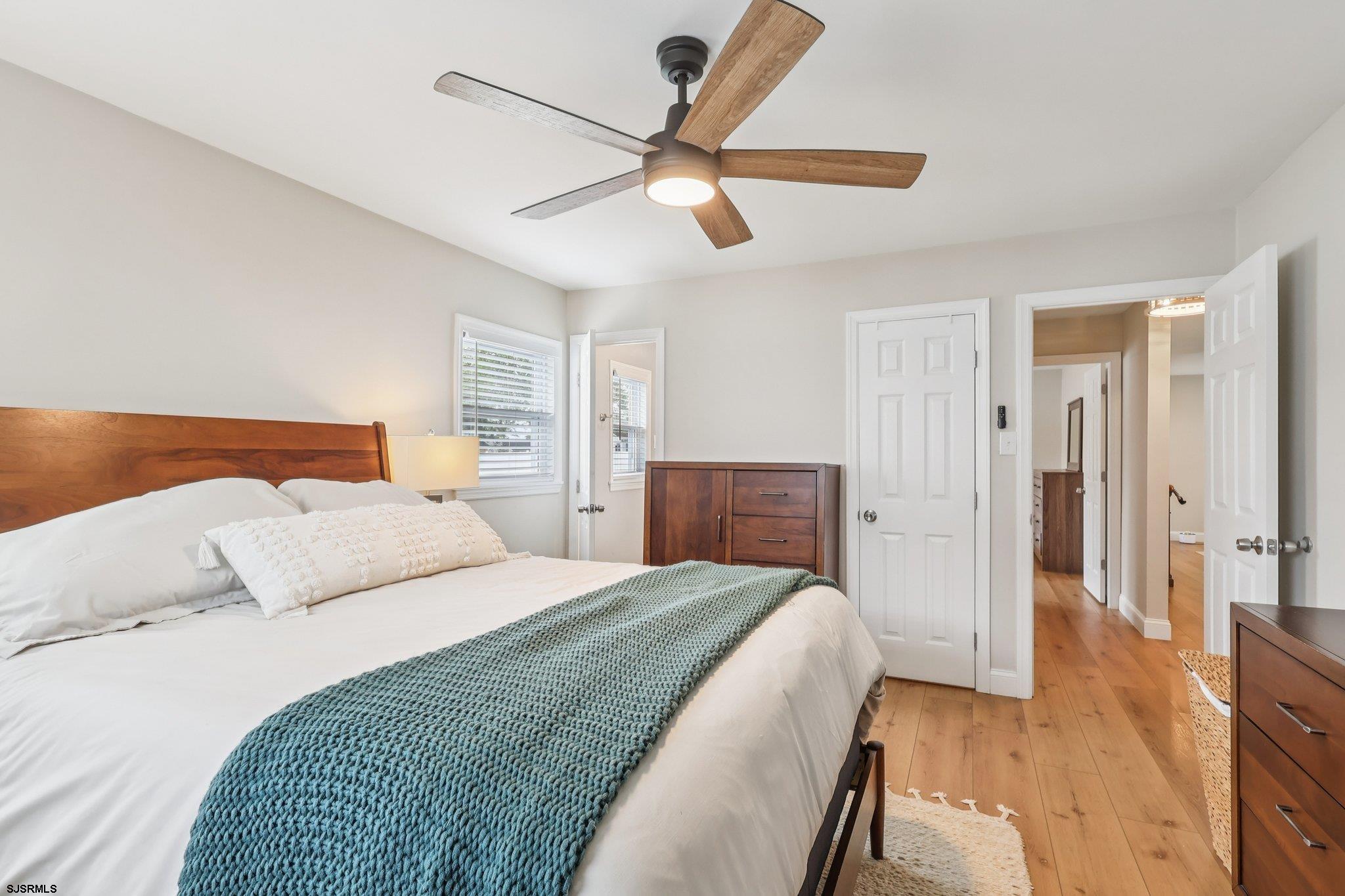 13 Gulph Mill Road Somers Point, NJ 08244 - Photo 30 of 43 a bedroom with a bed and a chandelier