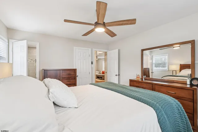 a bedroom with a large bed and a large window