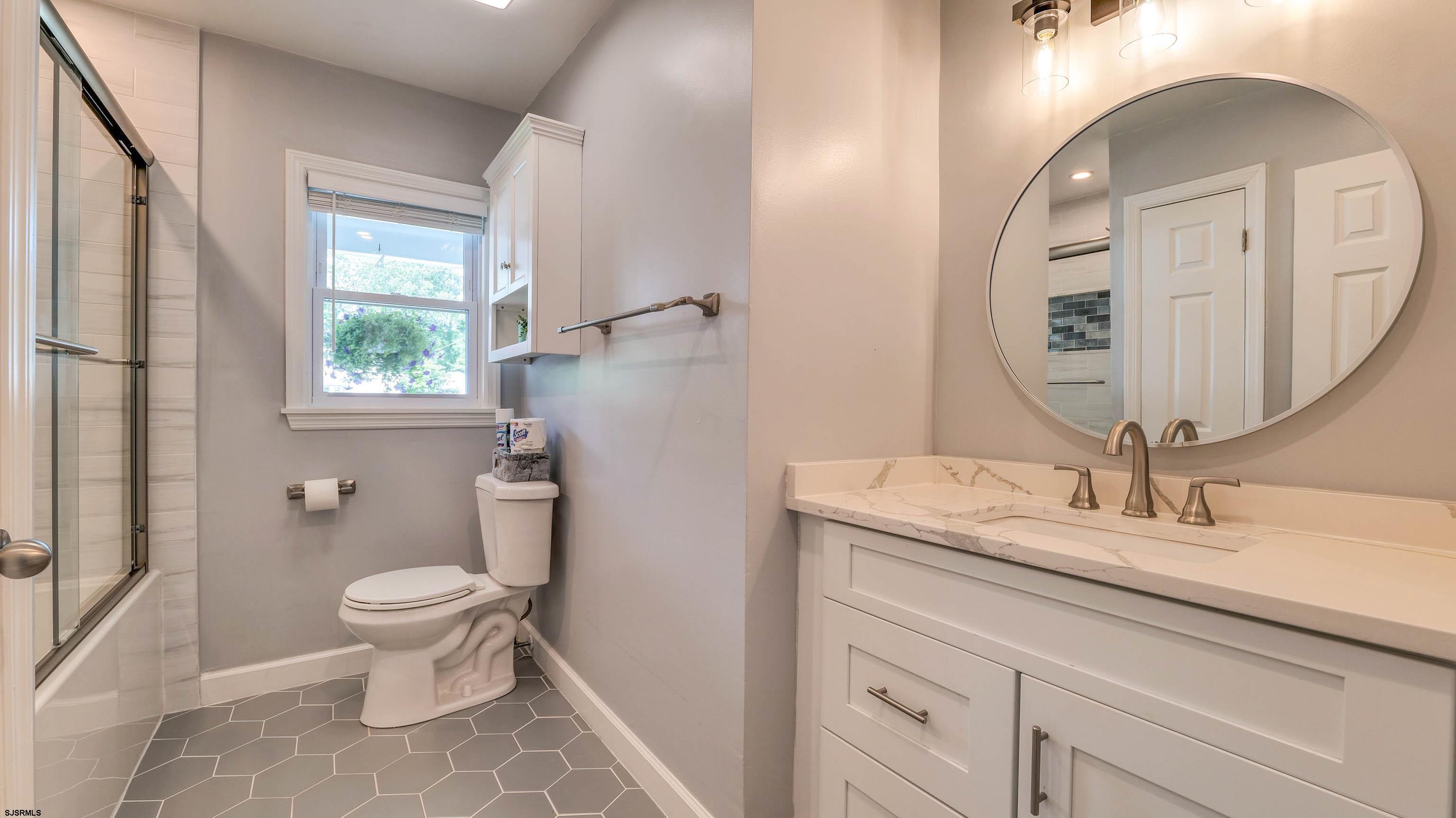 13 Gulph Mill Road Somers Point, NJ 08244 - Photo 32 of 43 a bathroom with a granite countertop toilet a sink and a mirror