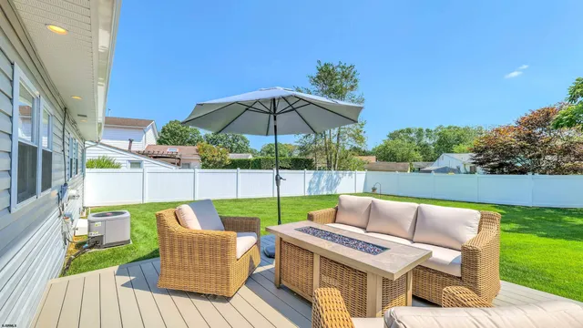 a view of an outdoor sitting area with furniture and umbrella