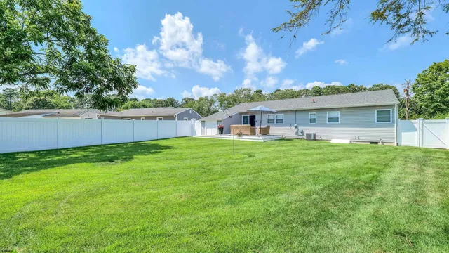 a view of house with a yard
