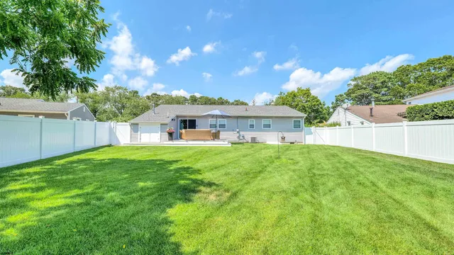 a view of house with backyard and a garden