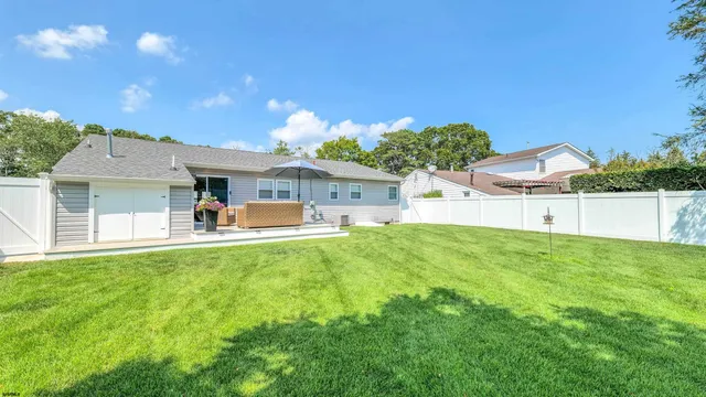 a front view of house with yard and outdoor seating