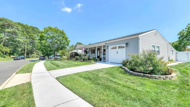 a view of a house with backyard and porch