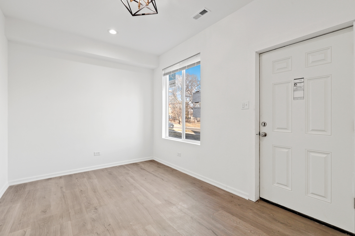 40 West Main Street Chicago Heights, IL 60411 - Photo 3 of 27 a view of an empty room with wooden floor and a window