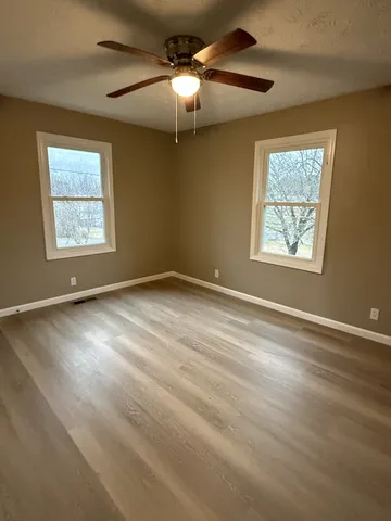 a view of room with window and ceiling fan