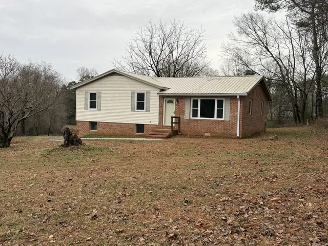 a view of house with a yard