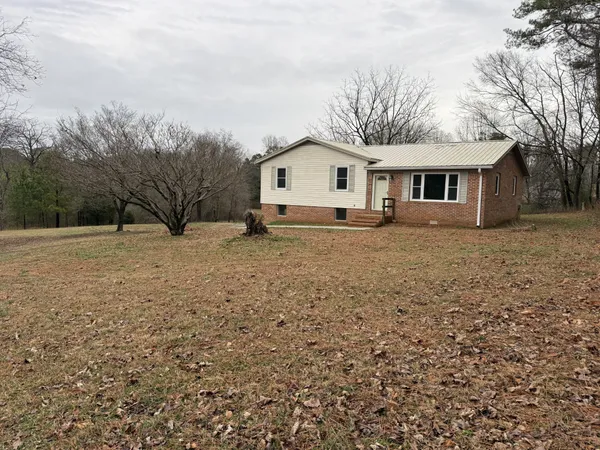 a large house with a large tree in front of a house