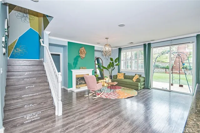 a dining hall with granite countertop a stove a sink and a wooden floors