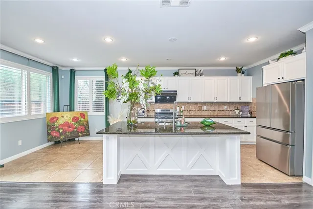 a living room with furniture a fireplace and a chandelier