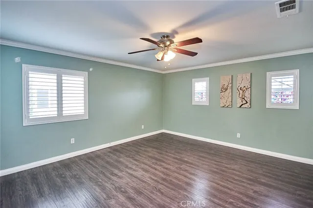 a bedroom with bed and a potted plant