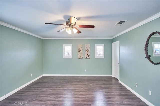 a bedroom with a bed chandelier and a window