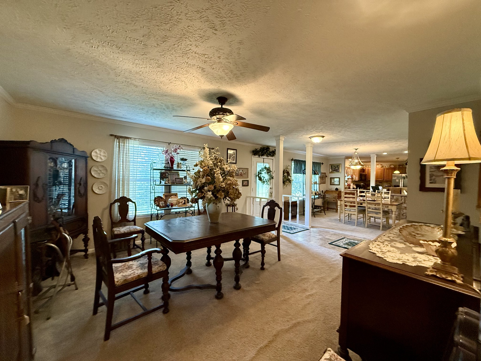 1640 Bucket Branch Road Waverly, TN 37185 - Photo 14 of 38 a view of a dining room and livingroom with furniture a flat screen tv and a painting