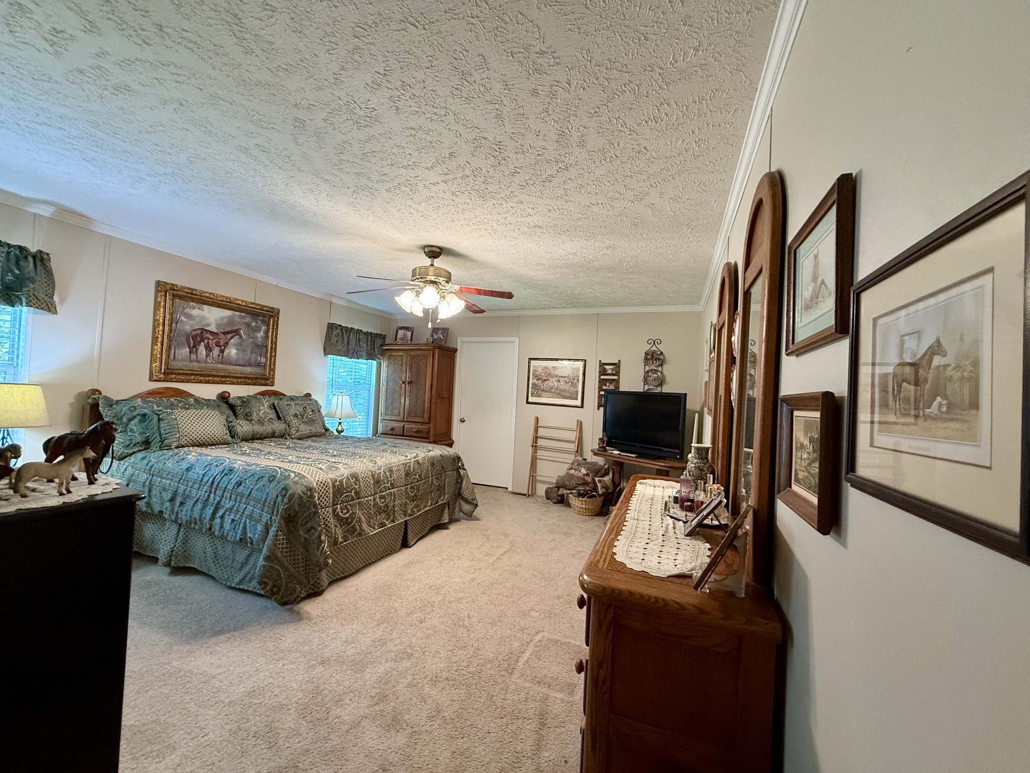 1640 Bucket Branch Road Waverly, TN 37185 - Photo 16 of 38 a bedroom with a bed couch and a flat tv screen on the dresser