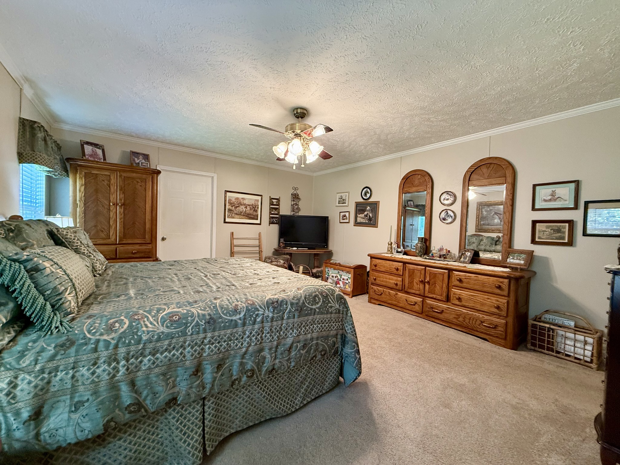 1640 Bucket Branch Road Waverly, TN 37185 - Photo 17 of 38 a spacious bedroom with a bed a dresser and mirror