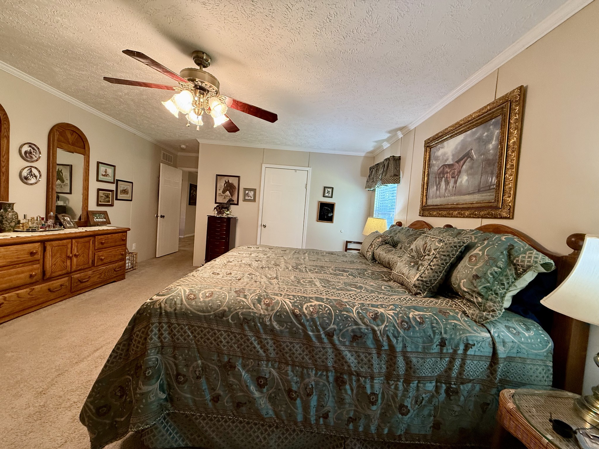 1640 Bucket Branch Road Waverly, TN 37185 - Photo 18 of 38 a bedroom with a large bed and a chandelier