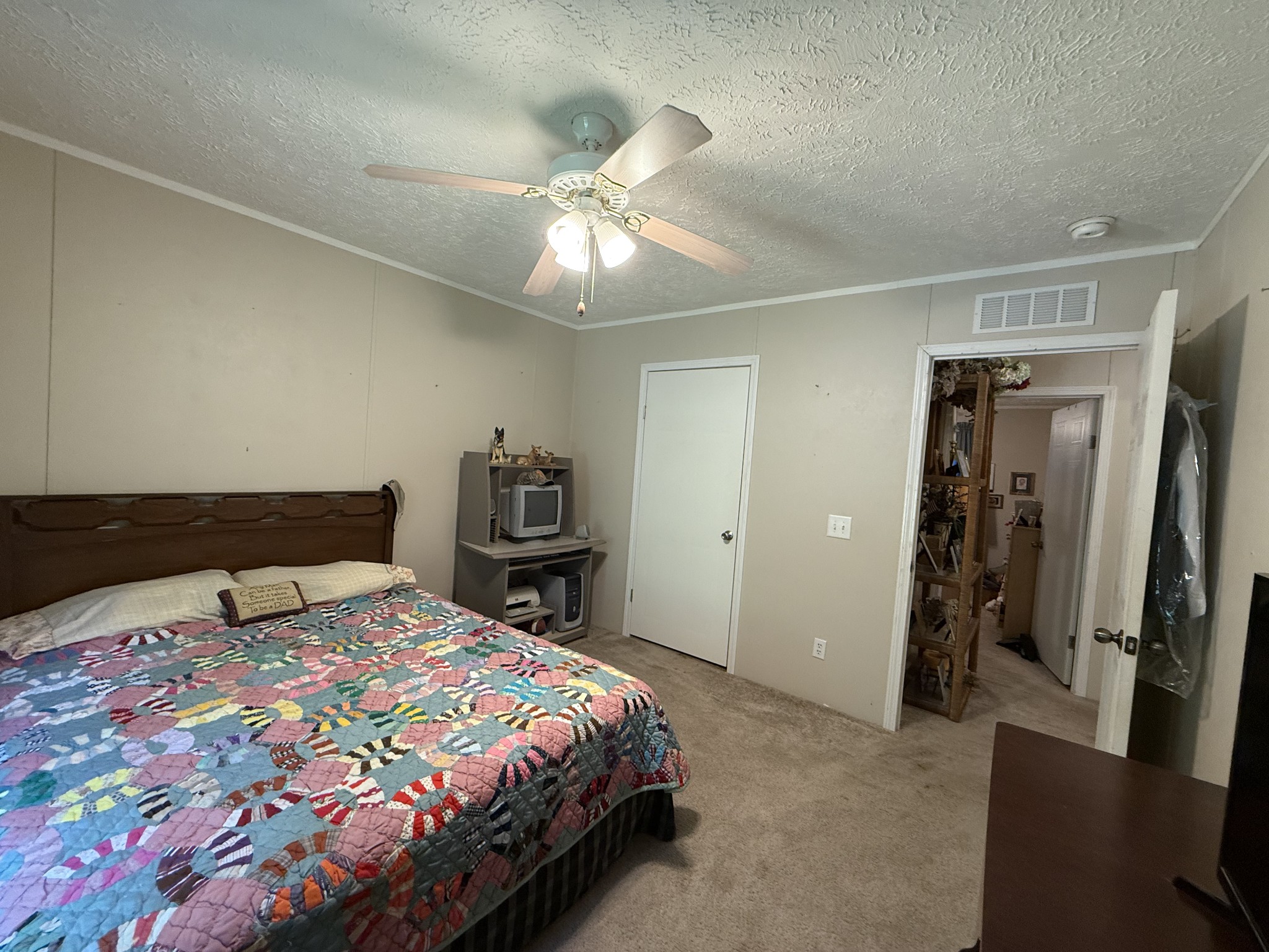 1640 Bucket Branch Road Waverly, TN 37185 - Photo 21 of 38 a bedroom with a bed and a chandelier