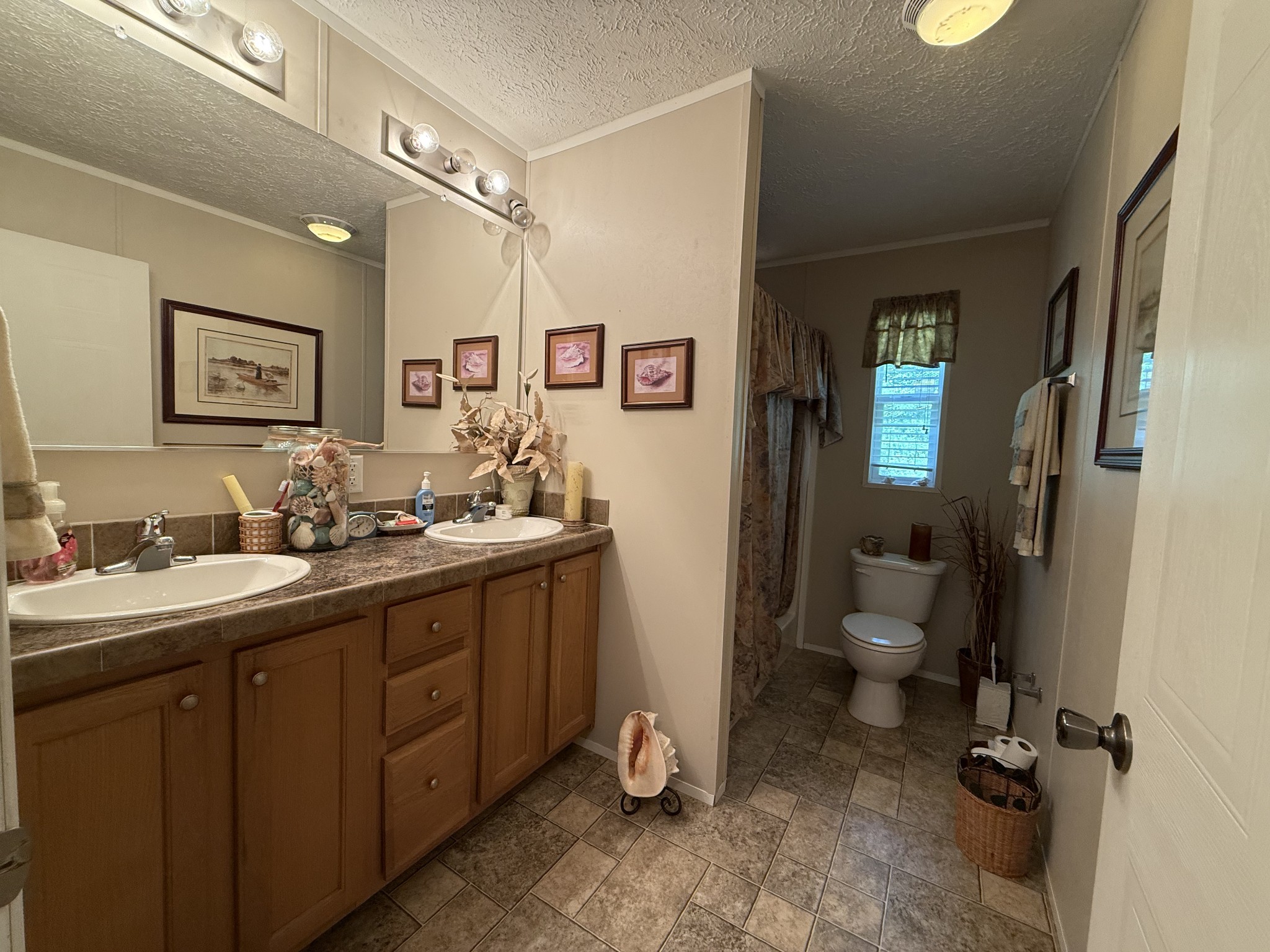1640 Bucket Branch Road Waverly, TN 37185 - Photo 22 of 38 a bathroom with a double vanity sink mirror and toilet