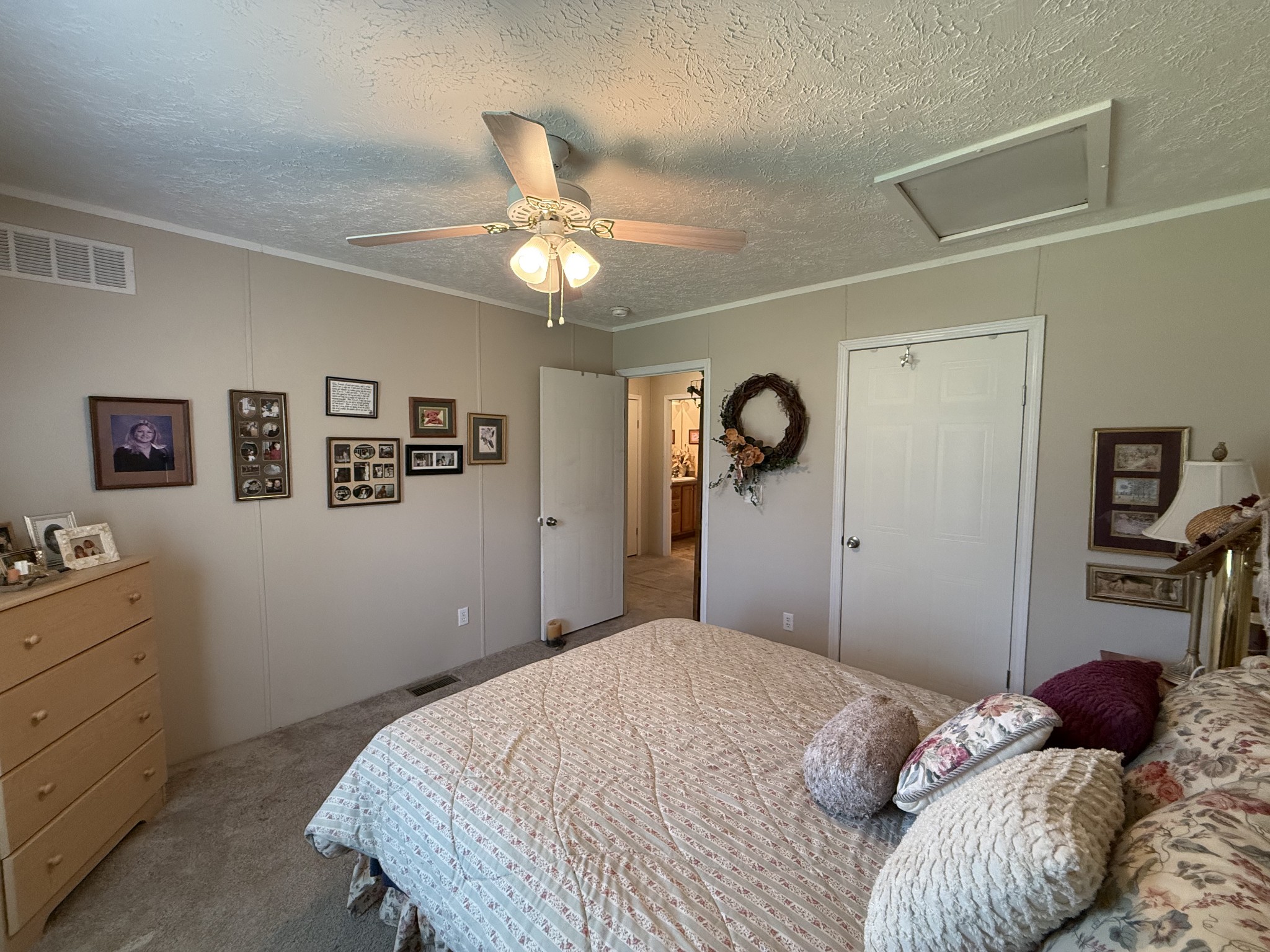 1640 Bucket Branch Road Waverly, TN 37185 - Photo 25 of 38 a bedroom with a bed and a chandelier