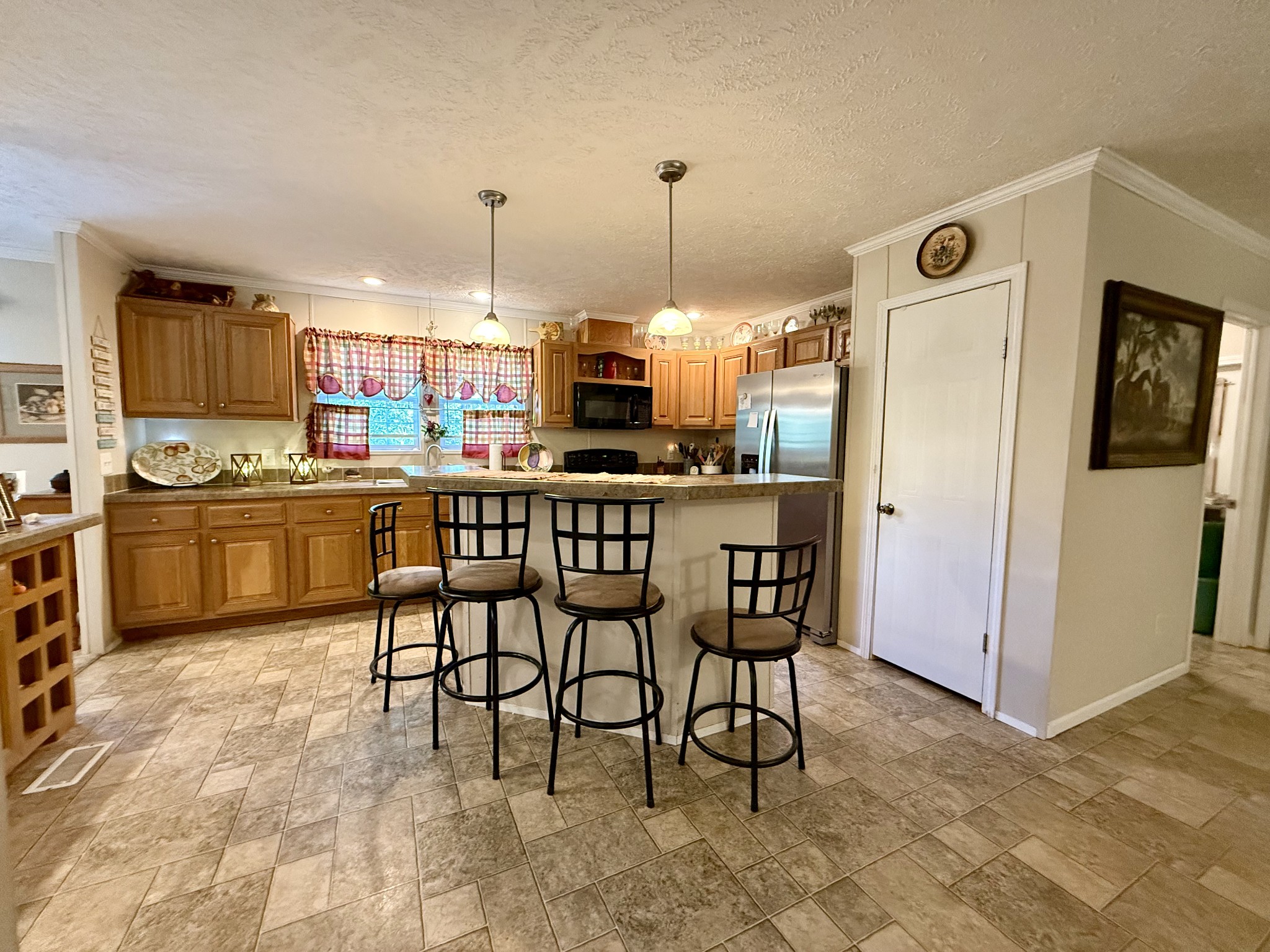 1640 Bucket Branch Road Waverly, TN 37185 - Photo 6 of 38 a kitchen with kitchen island a dining table chairs and a sink