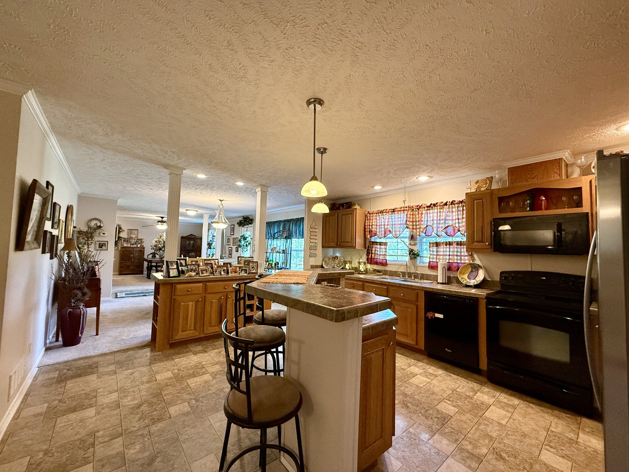 1640 Bucket Branch Road Waverly, TN 37185 - Photo 7 of 38 a kitchen with stainless steel appliances granite countertop a sink stove and refrigerator