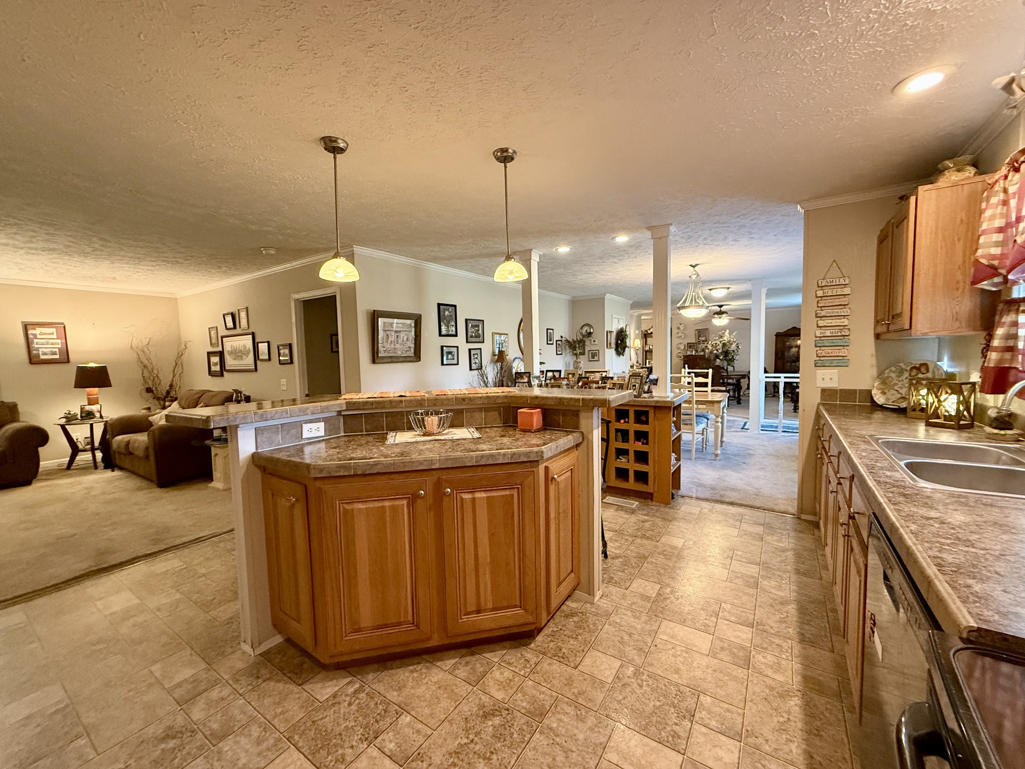 1640 Bucket Branch Road Waverly, TN 37185 - Photo 8 of 38 a large kitchen with kitchen island a stove a sink a counter top space and living room view