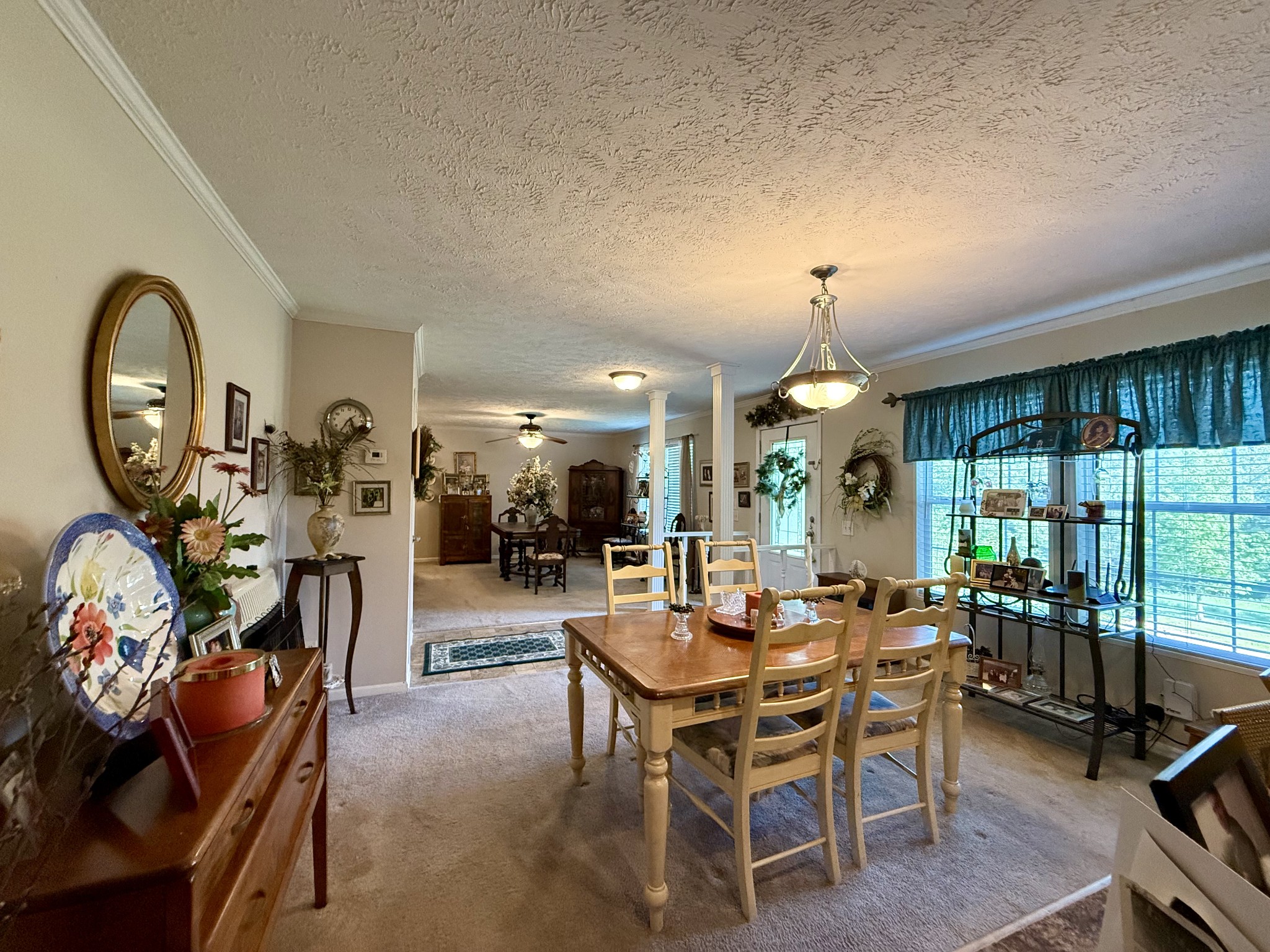 1640 Bucket Branch Road Waverly, TN 37185 - Photo 9 of 38 a view of a dining room with furniture and a chandelier
