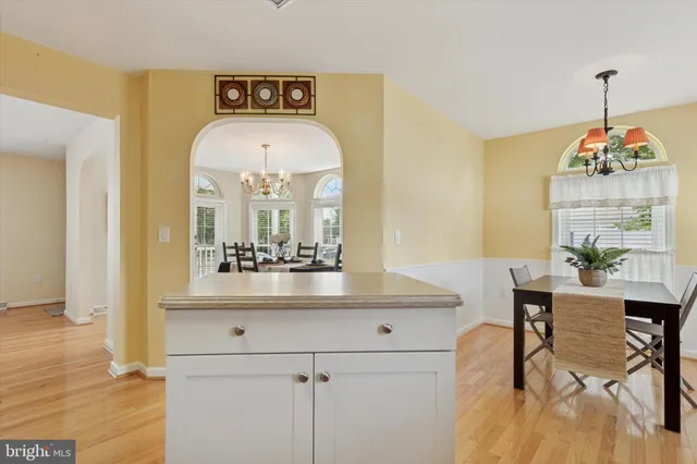 a view of a dining room with furniture and a chandelier