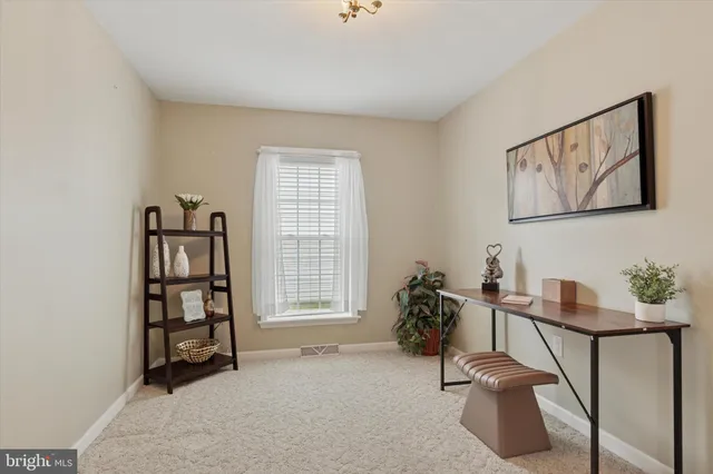 a view of a livingroom with furniture and a window