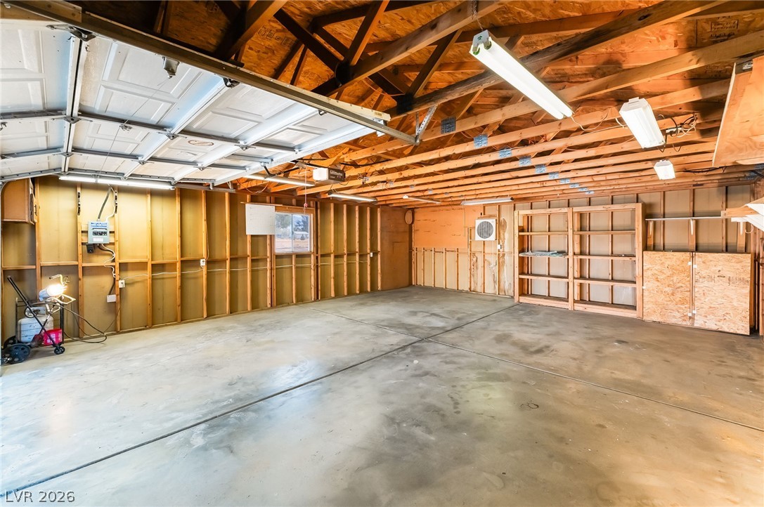 3631 South Blagg Road Pahrump, NV 89048 - Photo 2 of 47 A spacious garage with exposed wooden beams offers ample storage and parking versatility.