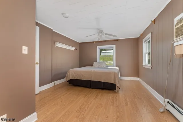 a bedroom with a bed and window