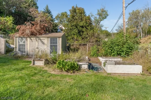 a view of a house with a yard and sitting area