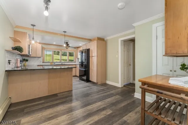 a kitchen with stainless steel appliances granite countertop a sink a stove a refrigerator and island