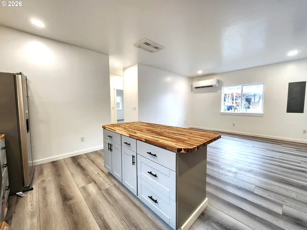 a spacious bathroom with a granite countertop sink a mirror and a toilet