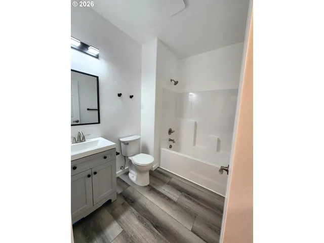 a bathroom with a toilet sink and a mirror