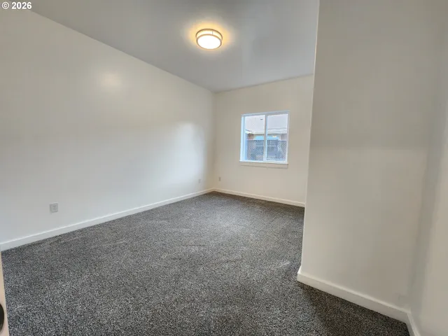 an empty room with a empty space and windows