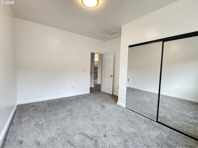 an empty room with sliding glass door