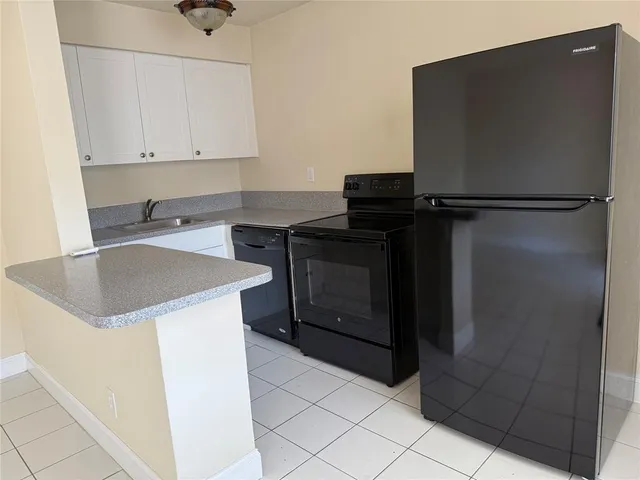 a kitchen with a refrigerator and cabinets