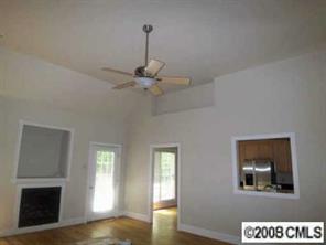 280 Patternote Road Mooresville, NC 28117 - Photo 6 of 8 a view of an empty room with wooden floor and a window