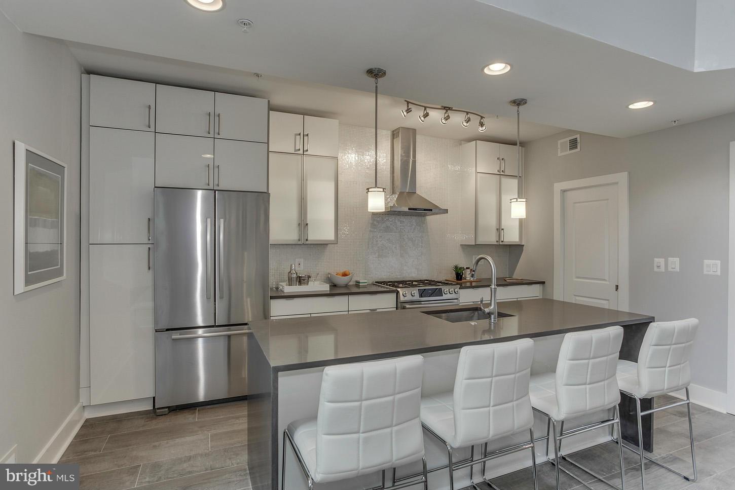 1839 6th Street Northwest, Unit 4 Washington, DC 20001 - Photo 14 of 29 a kitchen with stainless steel appliances granite countertop a refrigerator and a stove top oven