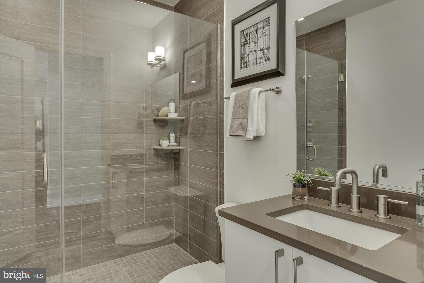 1839 6th Street Northwest, Unit 4 Washington, DC 20001 - Photo 16 of 29 a bathroom with a granite countertop sink a toilet and shower