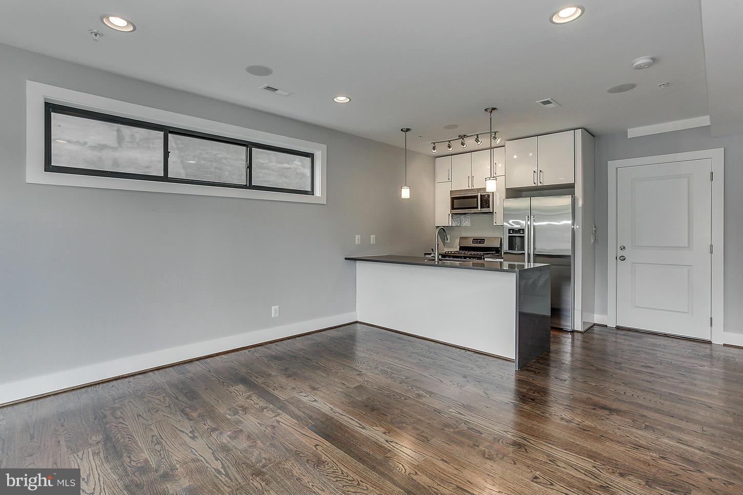 1839 6th Street Northwest, Unit 4 Washington, DC 20001 - Photo 3 of 29 a kitchen with stainless steel appliances granite countertop a refrigerator and a stove top oven