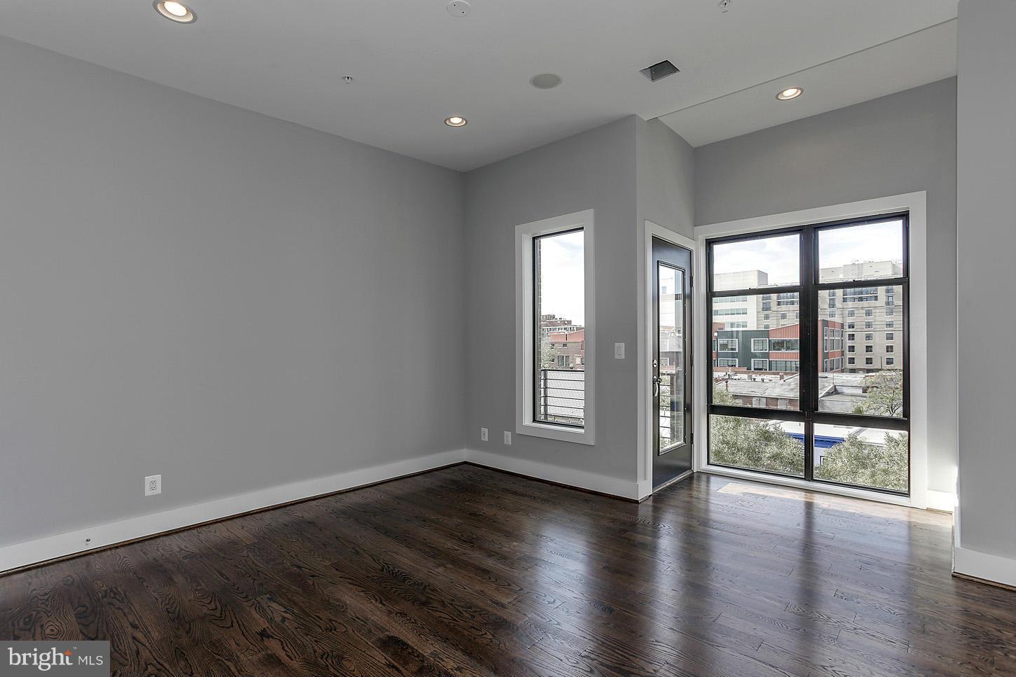 1839 6th Street Northwest, Unit 4 Washington, DC 20001 - Photo 24 of 29 an empty room with wooden floor and windows