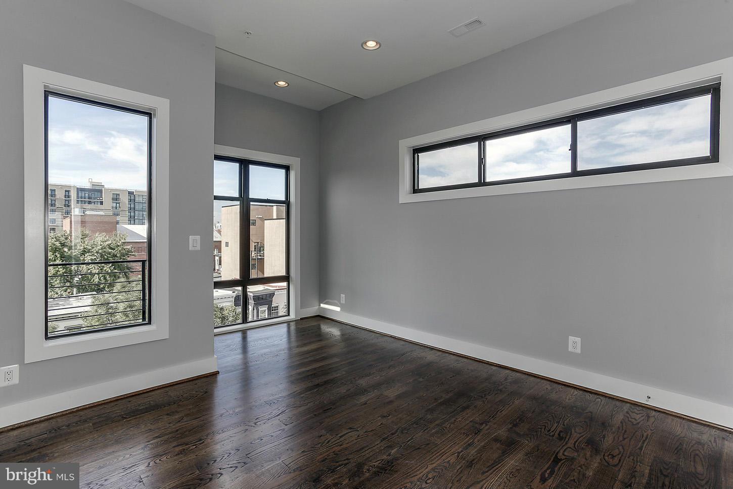 1839 6th Street Northwest, Unit 4 Washington, DC 20001 - Photo 26 of 29 a view of an empty room with wooden floor and a window