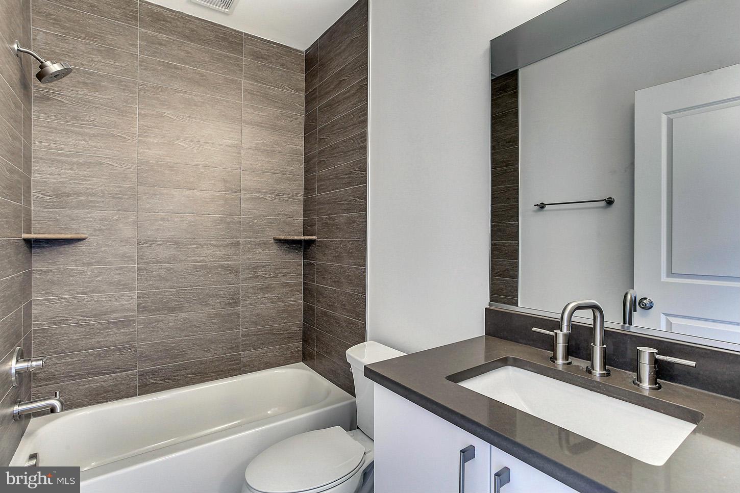 1839 6th Street Northwest, Unit 4 Washington, DC 20001 - Photo 27 of 29 a bathroom with a sink a toilet and bathtub