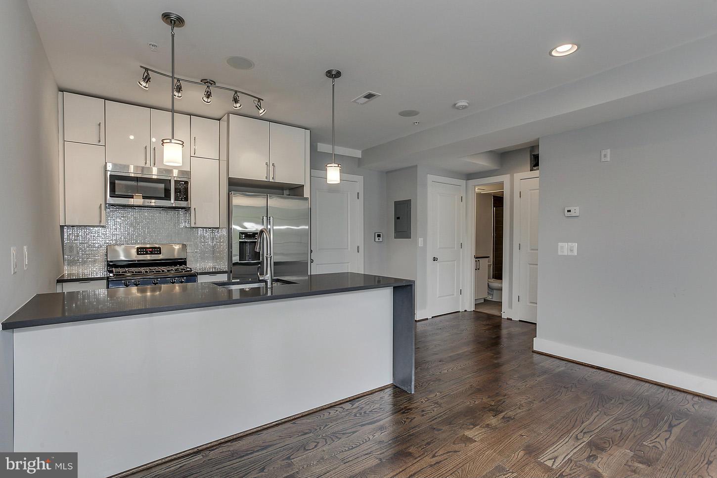 1839 6th Street Northwest, Unit 4 Washington, DC 20001 - Photo 4 of 29 a kitchen with stainless steel appliances a sink stove and refrigerator