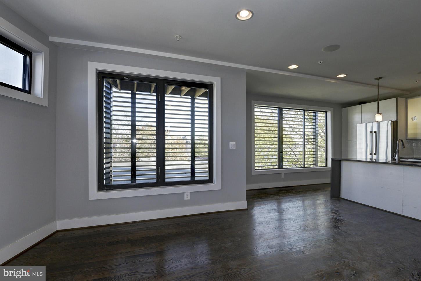 1839 6th Street Northwest, Unit 4 Washington, DC 20001 - Photo 8 of 29 a view of an empty room with wooden floor and a window