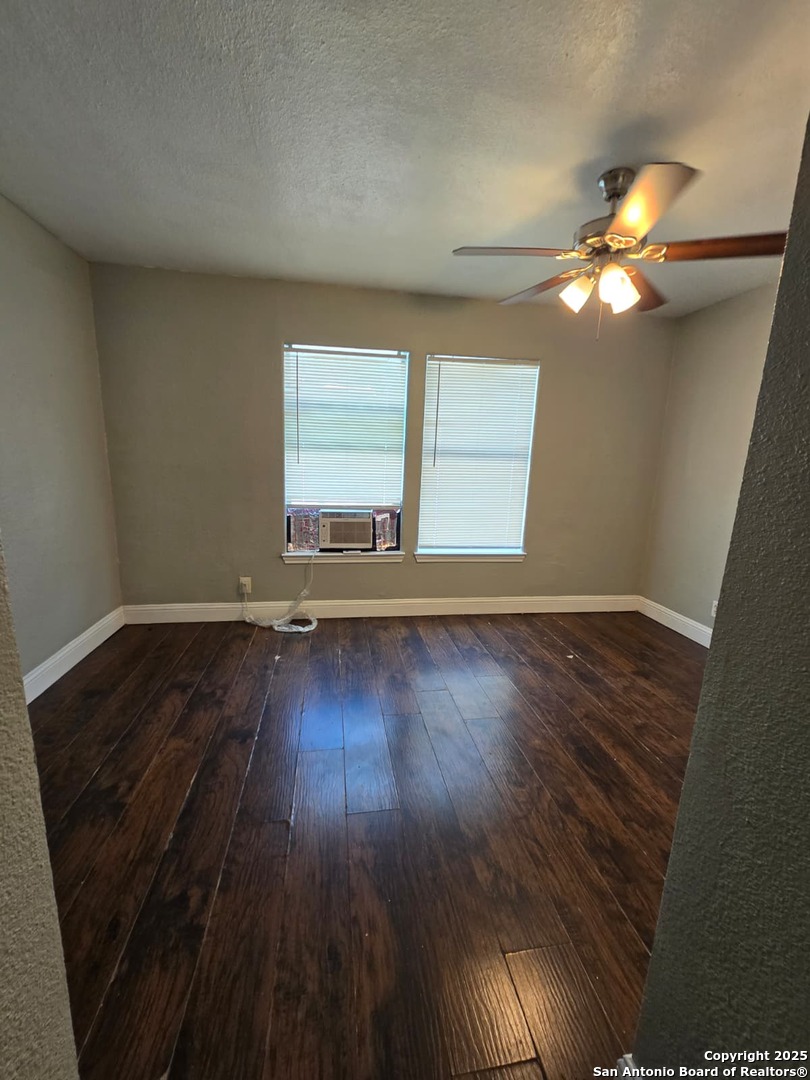 1718 Commercial, Unit B San Antonio, TX 78221 - Photo 12 of 13 a view of a livingroom with wooden floor and a ceiling fan