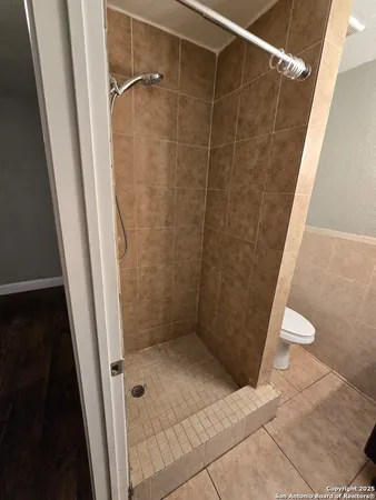 a bathroom with a shower and a toilet